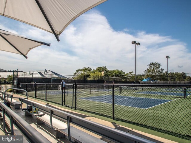 view of sport court featuring fence