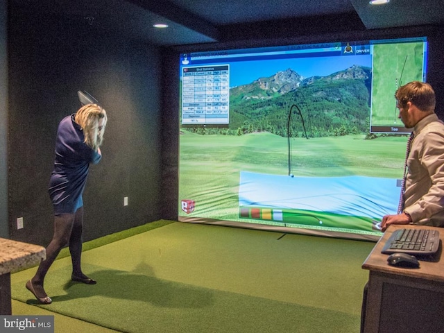 game room with carpet floors, golf simulator, a mountain view, and recessed lighting