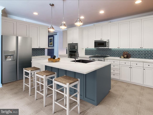 kitchen with light tile patterned floors, a sink, backsplash, and appliances with stainless steel finishes
