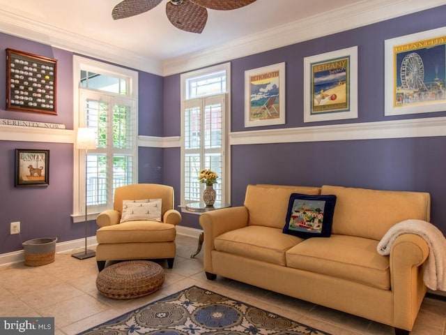 sitting room featuring ornamental molding, baseboards, a ceiling fan, and tile patterned floors