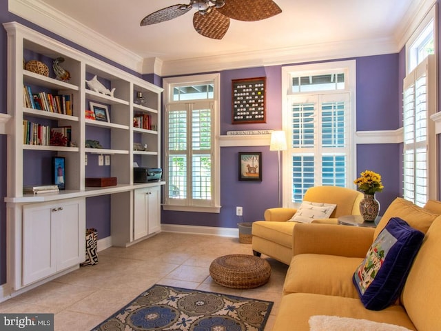 living area featuring ornamental molding, baseboards, ceiling fan, and light tile patterned floors