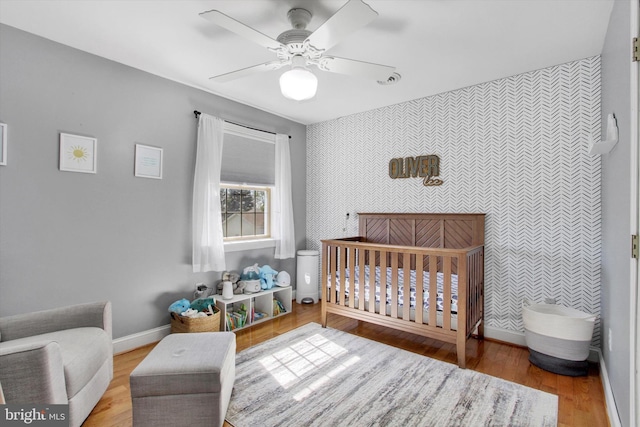 1664 Beech Ln, Hanover, PA 17331 - bedroom featuring baseboards, an accent wall, wallpapered walls, and a crib