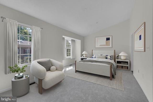 bedroom featuring carpet flooring, vaulted ceiling, and multiple windows