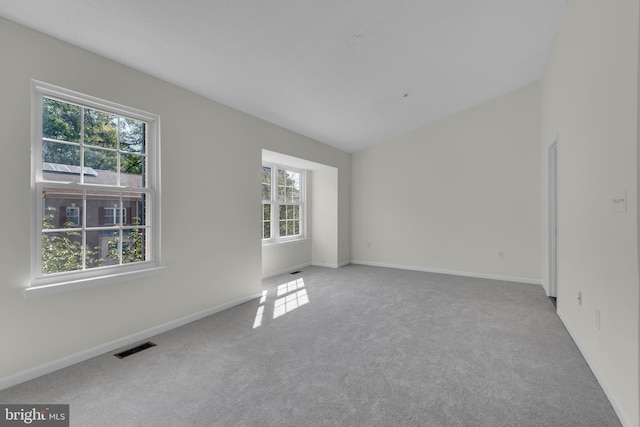 carpeted empty room with baseboards and visible vents