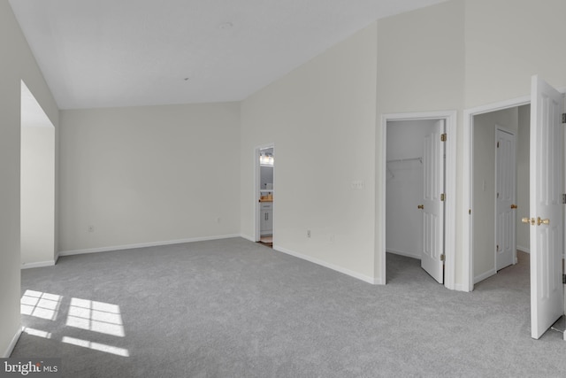 interior space featuring baseboards and high vaulted ceiling