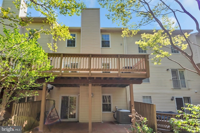 back of house with a patio, a chimney, cooling unit, and a deck