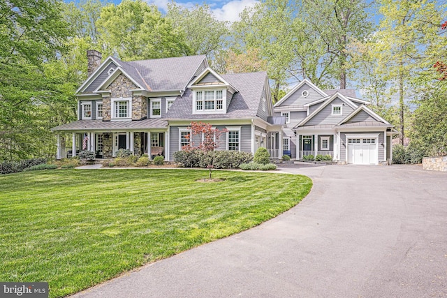 6020 Copely Ln, Mclean, VA 22101 - view of front of home featuring a front lawn, aphalt driveway, a chimney, a standing seam roof, and a porch