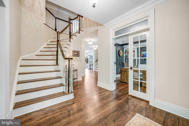 6020 Copely Ln, Mclean, VA 22101 - entryway with crown molding, baseboards, wood finished floors, and stairway