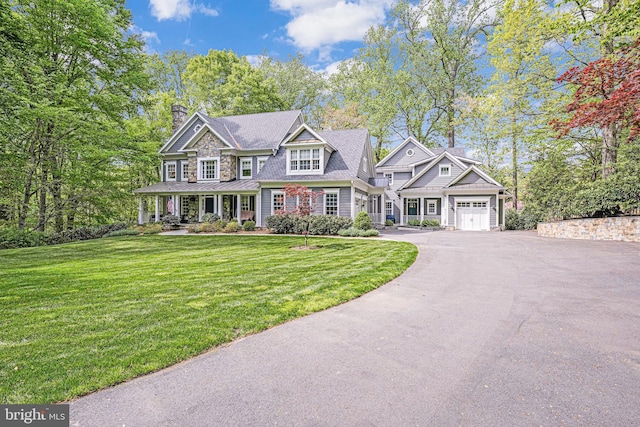 6020 Copely Ln, Mclean, VA 22101 - view of front of house featuring a garage, a chimney, driveway, and a front yard
