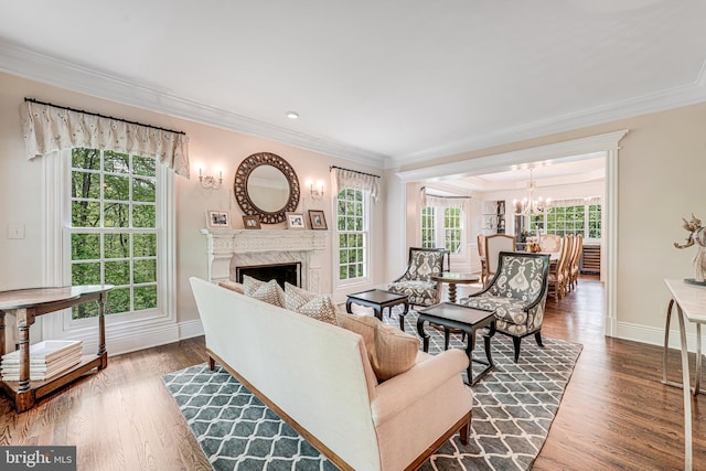 6020 Copely Ln, Mclean, VA 22101 - living area featuring a notable chandelier, a fireplace, dark wood finished floors, baseboards, and ornamental molding