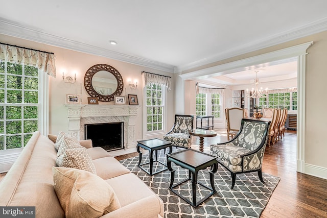 6020 Copely Ln, Mclean, VA 22101 - living area featuring a high end fireplace, wood finished floors, baseboards, an inviting chandelier, and ornamental molding