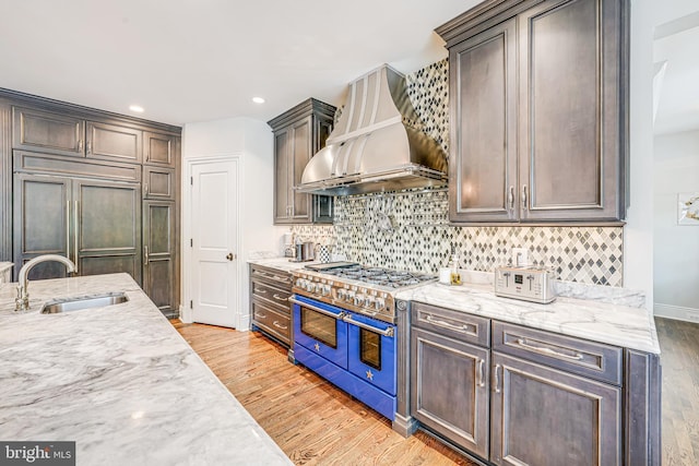 6020 Copely Ln, Mclean, VA 22101 - kitchen with high quality appliances, tasteful backsplash, custom range hood, a sink, and light wood finished floors