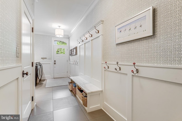 6020 Copely Ln, Mclean, VA 22101 - mudroom with wallpapered walls, washing machine and dryer, ornamental molding, and tile patterned flooring