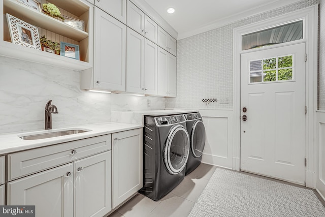 6020 Copely Ln, Mclean, VA 22101 - laundry area with crown molding, cabinet space, a sink, light tile patterned floors, and washer and clothes dryer