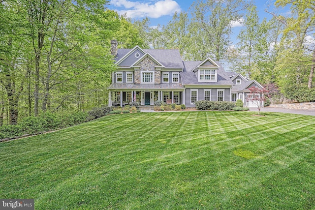 6020 Copely Ln, Mclean, VA 22101 - view of front of house featuring a front lawn, a garage, a porch, a chimney, and concrete driveway