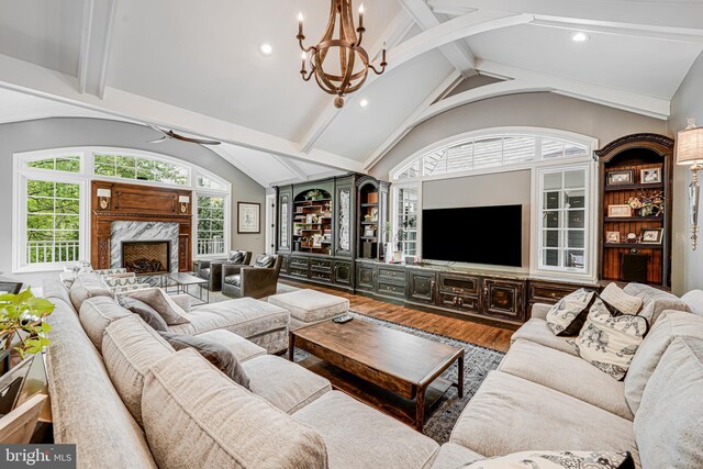 6020 Copely Ln, Mclean, VA 22101 - living area with vaulted ceiling with beams, a high end fireplace, ceiling fan with notable chandelier, and wood finished floors