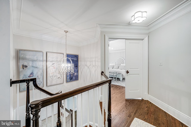 6020 Copely Ln, Mclean, VA 22101 - hall featuring crown molding, dark wood-style flooring, baseboards, a chandelier, and an upstairs landing