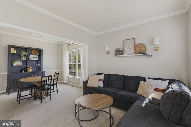 living area featuring baseboards, ornamental molding, and light colored carpet