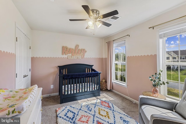 bedroom with a ceiling fan, visible vents, carpet floors, and baseboards