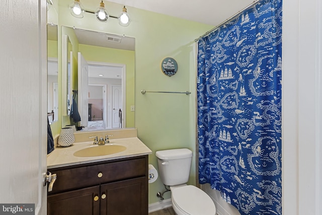 bathroom featuring visible vents, toilet, a shower with shower curtain, and vanity
