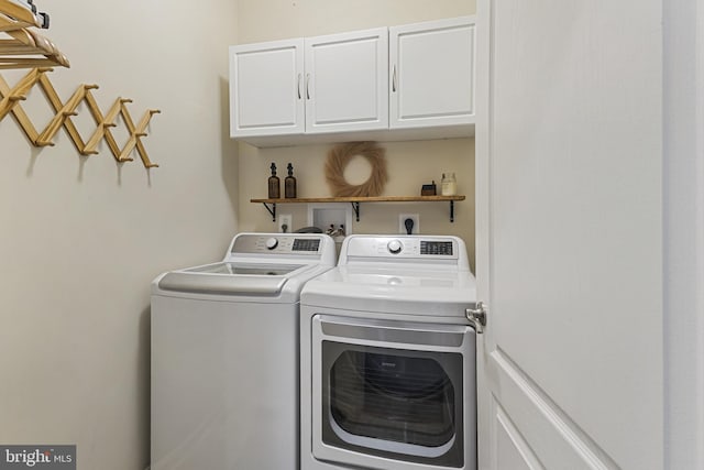laundry area with cabinet space and washer and clothes dryer