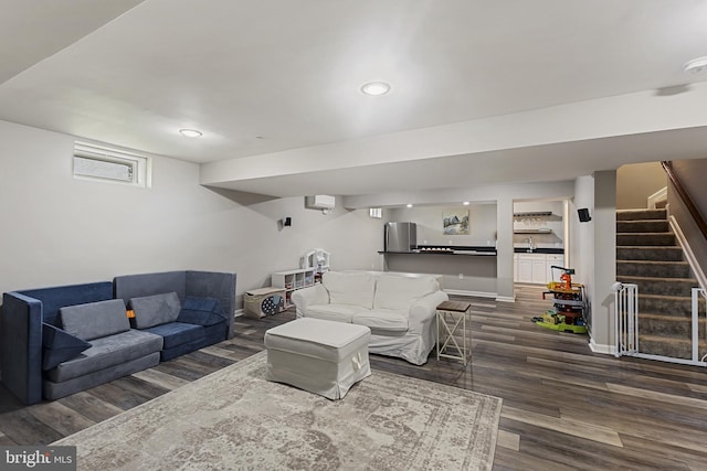 living area featuring stairway, wood finished floors, recessed lighting, and radiator