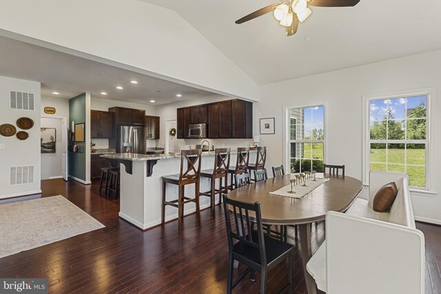 dining room featuring dark wood-style floors, visible vents, ceiling fan, and baseboards