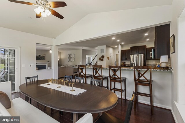 dining room featuring baseboards, recessed lighting, vaulted ceiling, dark wood-type flooring, and a ceiling fan