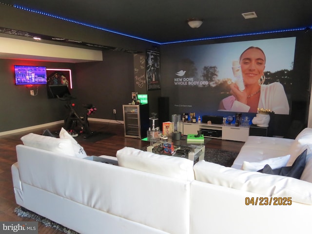 cinema room with baseboards and wood finished floors
