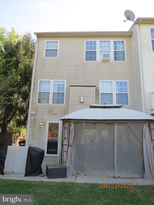rear view of house featuring a sunroom