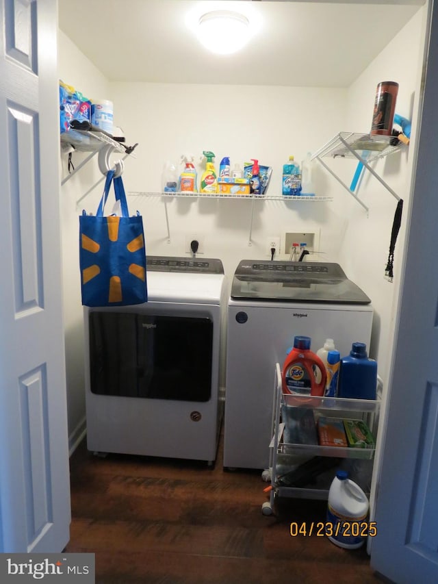 laundry room featuring washing machine and dryer, wood finished floors, and laundry area
