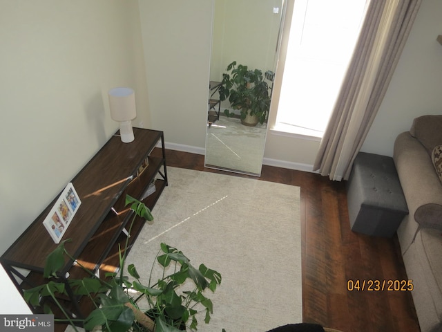 interior space with wood finished floors and baseboards