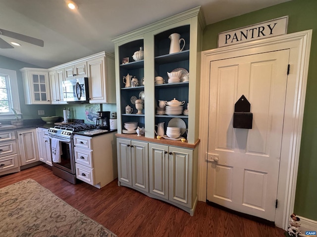 kitchen with white cabinets, ceiling fan, open shelves, appliances with stainless steel finishes, and dark wood-style flooring