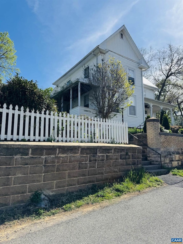 view of front of home with a porch and a fenced front yard