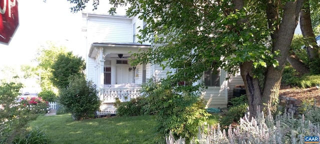 view of front of home featuring stairway, a porch, and a front lawn