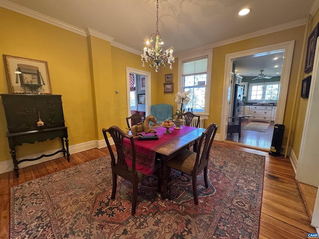 dining space featuring baseboards, recessed lighting, a chandelier, crown molding, and wood-type flooring