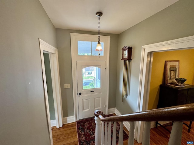 entryway with baseboards and wood finished floors