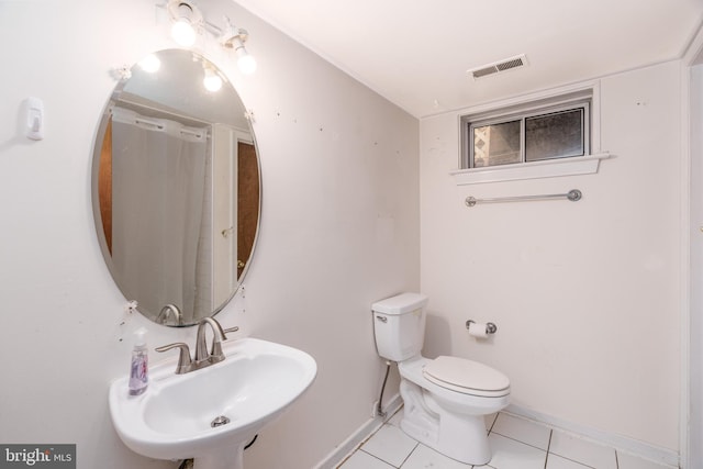 bathroom with tile patterned floors, visible vents, baseboards, and a sink