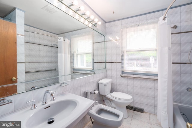 full bath with tile walls, a sink, toilet, visible vents, and a bidet