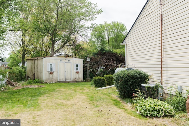 view of yard with a shed and an outbuilding