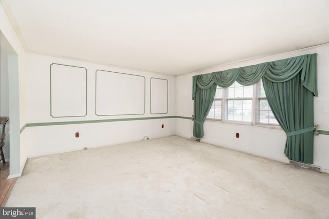 carpeted empty room featuring visible vents