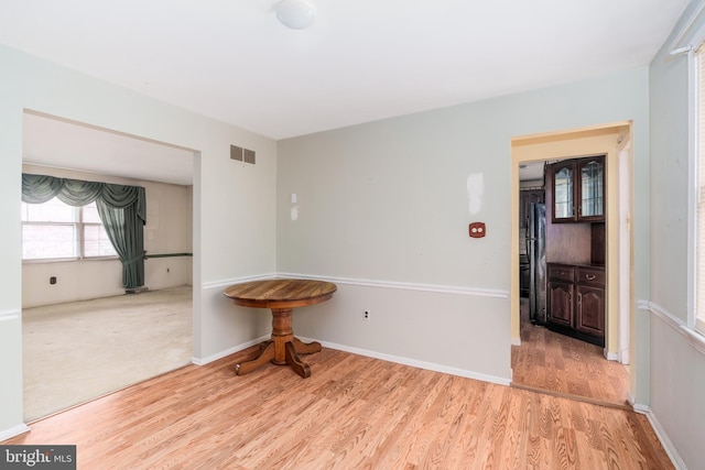 unfurnished room with visible vents, baseboards, and light wood-style floors