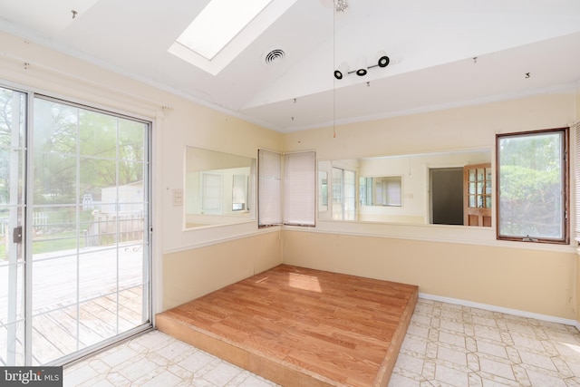 unfurnished sunroom with visible vents and a skylight