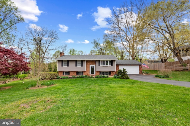 2411 Nickoles Dr, Sykesville, MD 21784 - raised ranch featuring a chimney, driveway, fence, a garage, and brick siding