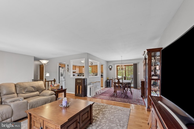 2411 Nickoles Dr, Sykesville, MD 21784 - living room with light wood-type flooring and a notable chandelier