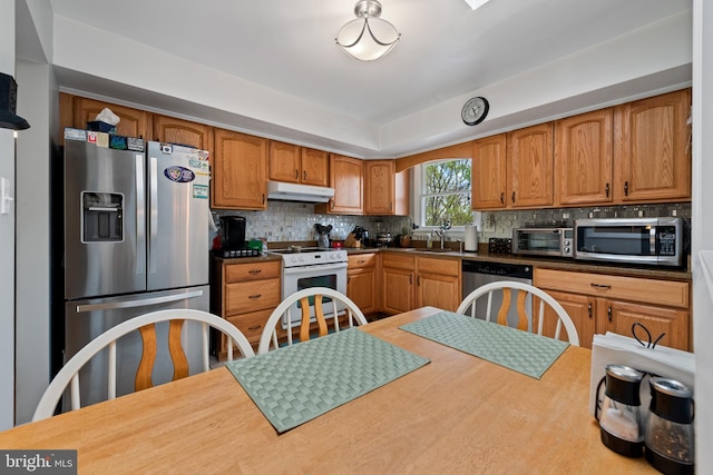 2411 Nickoles Dr, Sykesville, MD 21784 - kitchen with stainless steel appliances, a sink, decorative backsplash, brown cabinetry, and under cabinet range hood