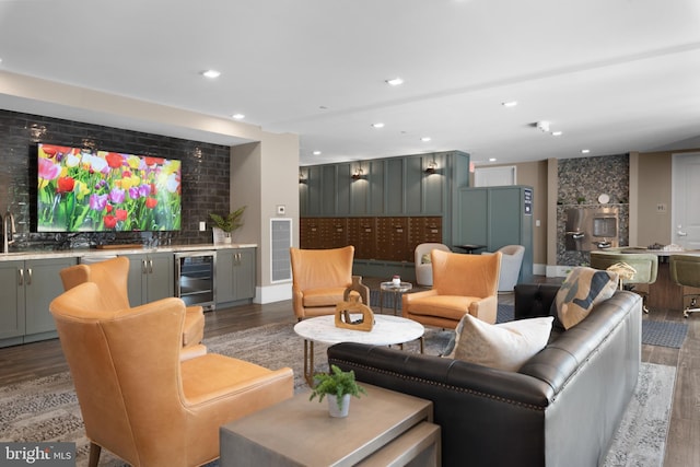 living room featuring visible vents, beverage cooler, indoor wet bar, recessed lighting, and light wood finished floors