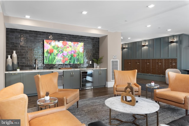 interior space featuring dark wood-style flooring, tasteful backsplash, a sink, indoor wet bar, and wine cooler