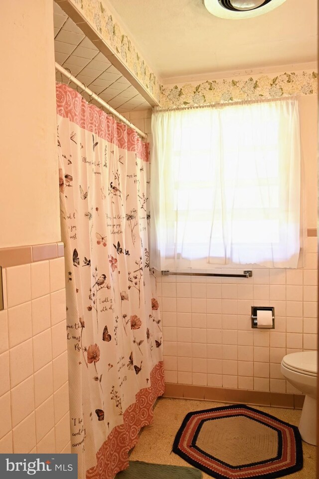 4092 Manchester St, Glen Rock, PA 17327 - bathroom with tile walls, healthy amount of natural light, toilet, curtained shower, and a wainscoted wall