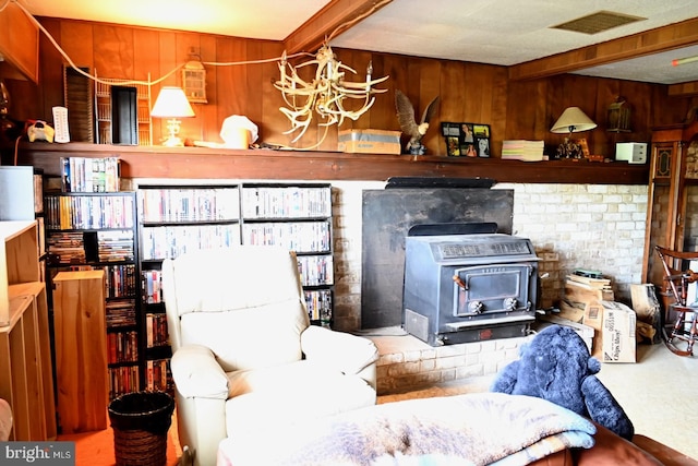 4092 Manchester St, Glen Rock, PA 17327 - living room featuring a wood stove, wood walls, and a chandelier